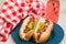 Two Delicious Hot Dogs On Blue Plate
