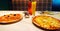 Two delicious hot pizzas and drinks on the table