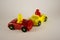 Two desperate men in toy cars involved in accident, conceptual image with miniatures and figurines on white background. Close-up