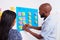 Two developers move tickets on scrum board during sprint planning