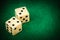 Two dice on a green gaming table