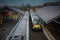 Two diesel trains are crossing at ballymoney train station in northern ireland. Looking towards the trains and train tracks from