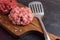 Two Different Balls Of Minced Meat: Beef And Pork Got Placed On A Wooden Board Separately. Culinary Preparation. Hamburger