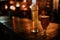 Two different beers on a wooden table, with pub lights in the background at night