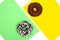 Two different donuts on green and yellow background