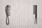 Two different hairbrushes lying opposit to each other