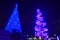 Two different iluminated Christmas Trees at night in International Drive area .