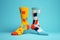 Two different mismatched socks on light blue geometric shape background. Fashion, Odd Socks Day, Lonely Sock Day, Anti