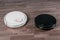 Two different Robotic vacuum cleaners on dark laminate floor, smart home robotics wireless cleaning for simplify routine housework