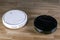 Two different robotic vacuum cleaners models cleaning dust on laminate floors. Modern smart cleaning technology housekeeping.