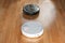 Two different robotic vacuum cleaners models cleaning dust. Modern smart cleaning technology housekeeping. Close up