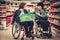 Two disabled woman in a wheelchairs in a grocery store