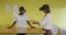 Two diverse female coworkers standing at desk, testing vr googles