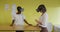 Two diverse female coworkers standing at desk, testing vr googles