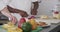 Two diverse male chefs cutting vegetables in kitchen, slow motion