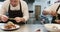 Two diverse male chefs decorating meals in kitchen, slow motion