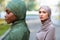 Two Diverse Muslim Women Posing Outdoors, Wearing Traditional Hijab