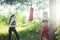 Two diverse nations girls fighting boxing outside in green park, sport summer people concept