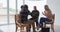 Two diverse senior couples sitting in circle having a therapy conversation at home