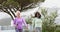 Two diverse senior women walking water bottles talking on sunny day, slow motion