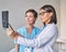 Two diverse women doctors in uniform looking at brain tomography and discussing diagnosis