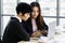 Two diversity businesswoman working together at desk in office