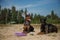 Two doberman dogs with puller lying on the sand