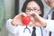 Two docter holding a red heart, health care concept.