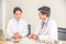 Two doctors discuss and ask for each other opinion about patient case