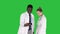 Two doctors are making selfie using a smartphone and smiling on a Green Screen, Chroma Key.