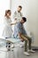 Two doctors, a man and a woman, examine a young patient in a hospital office.