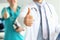 Two doctors show thumb up gesture with hands