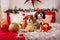 Two dogs of Cavalier King Charles Spaniel are lying on the sofa with New Year decorations for the Christmas tree. Dog