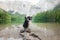 Two dogs perch on a rock amidst a mountain lake, of the alpine wilderness