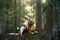 Two dogs together in the forest. Duck Retriever Jack Russell Terrier in nature. Pet friendship