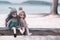 Two dolls so cute sitting on wood swing with sea beach background