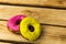 Two donuts pink and yellow on a wooden background. Free space for text. World donut day