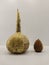 two dried gourds, one large with spots and one small reddish