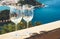 Two drink glass white wine standing on background blue sea top view city coast yacht from observation deck, romantic toast