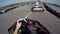 Two drivers drive go kart and overtaking on outdoor track, camera is attached to the helmet,