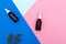 Two dropper bottles on a colorful paper background. Flatlay beauty concept.