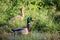 Two ducks in some long grass.