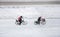 Two Dutch cyclist racing on the cycling path covered by a tick layer of snow