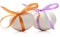 Two Easter eggs with festive orange and purple bow on w