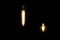 Two Edison Lamps Glow in the Dark with Dull Yellow