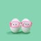 Two eggs in pink glasses like Siamese twins