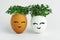 Two eggs with seedlings inside. A cute face is painted on the shell. Concepts of Easter decor, growing micro-greenery for food,