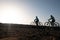 Two elderly athletes man and woman bicycling along the cliff. Freedom and healthy lifestyles