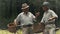 Two elderly friends with bicycles are talking in the park