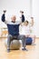 Two elderly patients exercising with weights in rehabilitation center